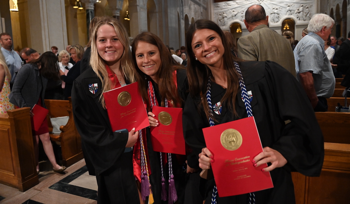 students smile with their honors certificate at honors convocation