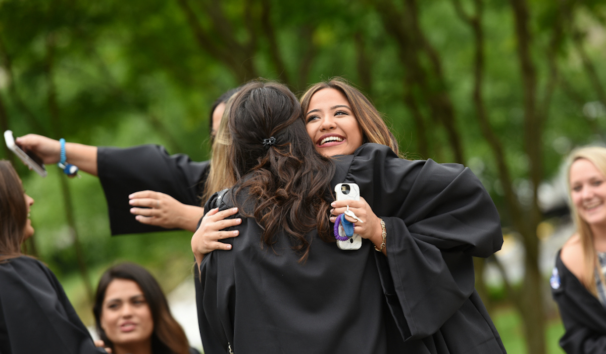 Friends hugging at Commencement