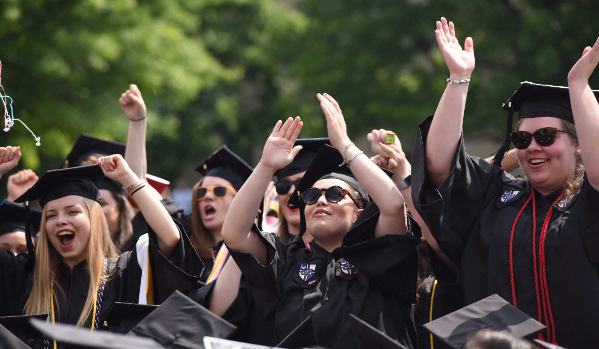Graduates cheering at Commencement