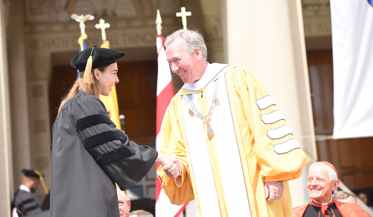 President Garvey congratulating student at Commencement