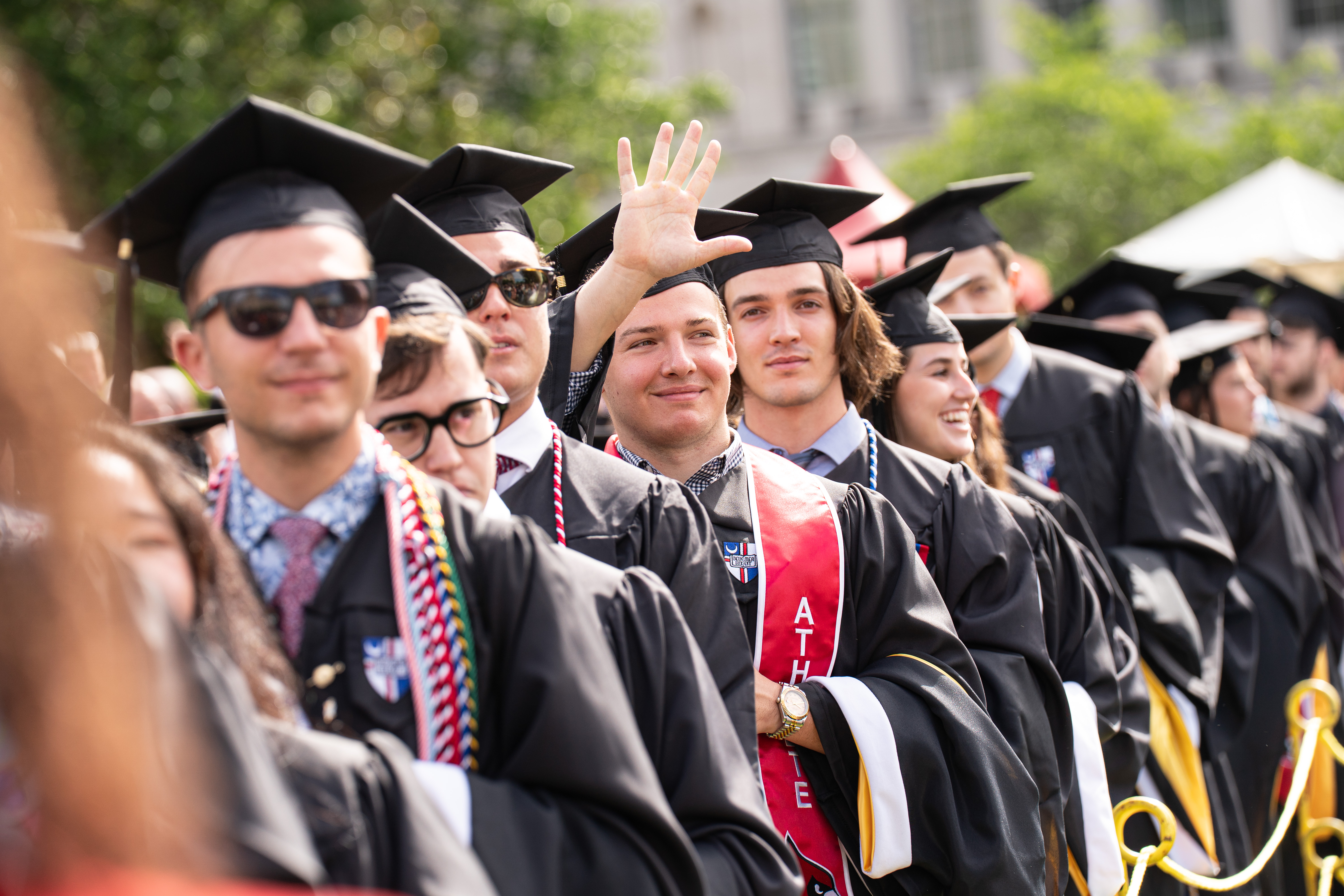 Graduate waving at commencement